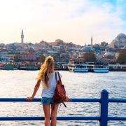 Young Woman Admiring A View Of The Historical Peninsula Of Istanbul From Galata Bridge, Istanbul, Turkiye Or Turkey Western Asia, Eastern Europe.jpg